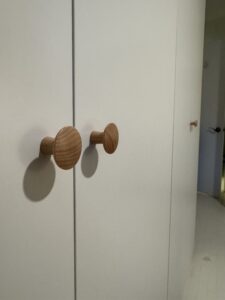 Close-up of IKEA PAX wardrobe installed in Vancouver with sleek door knob detail.