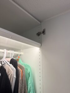 Inside view of IKEA PAX wardrobe installation in Vancouver showing hanging clothes and storage space