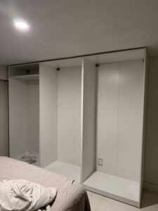 Full interior view of custom-installed IKEA PAX wardrobe in Vancouver with organized shelving and hanging space
