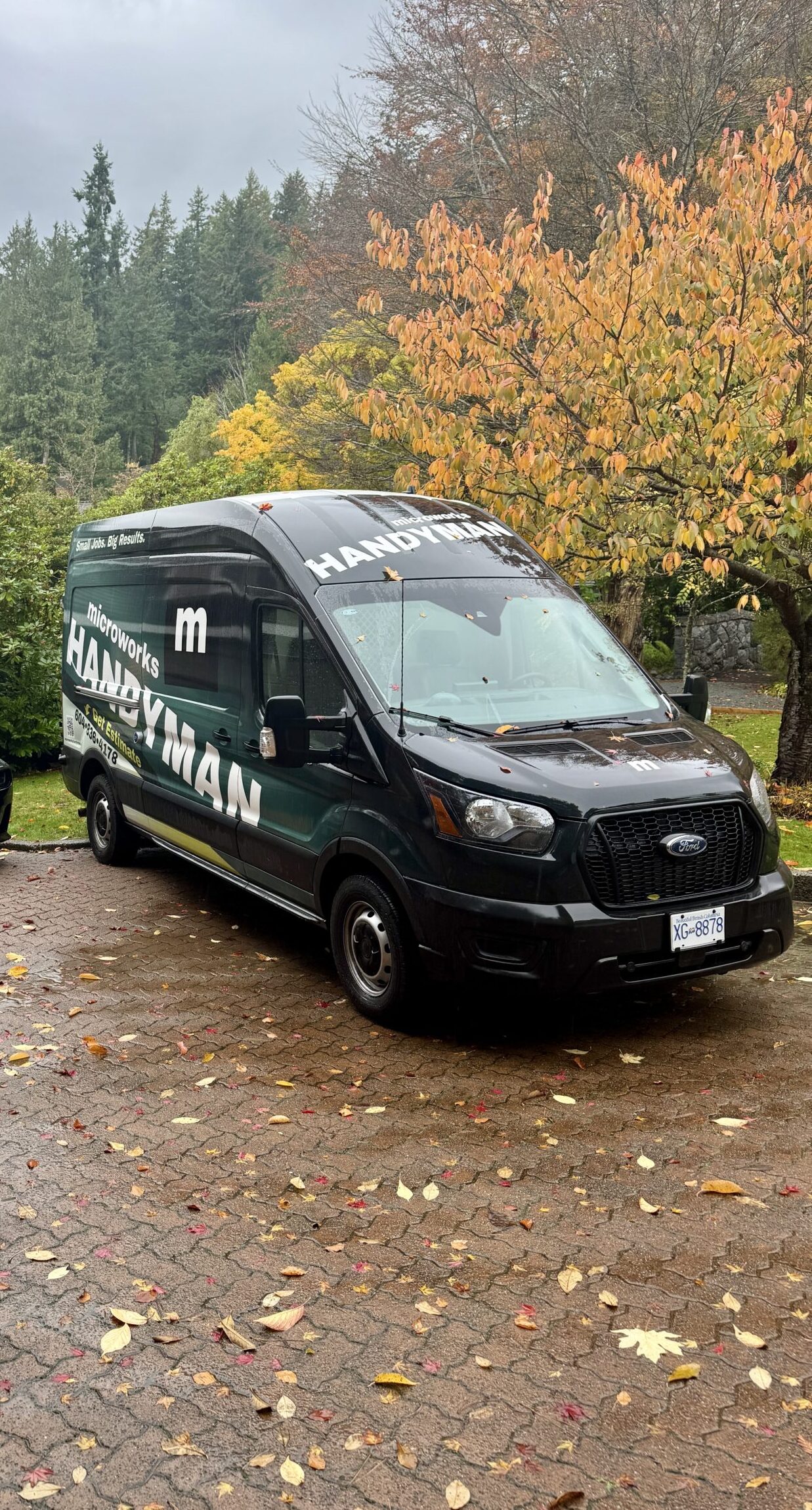 A van parked outside of a home, ready to work